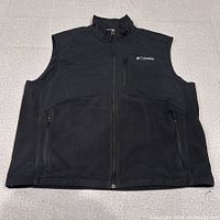 Front view of black Columbia Omni-Shield vest laid flat