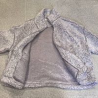 Jacket opened showing interior fleece lining and construction