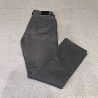 Full view of folded grey Hugo Boss jeans