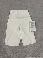 Front view of white Align HR 8" shorts with tag attached