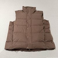 Front view of brown Lululemon down vest laid flat