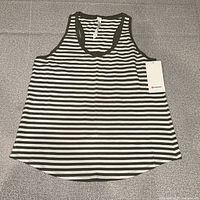 Full view of the striped Love Tank laid flat showing design, cut, and attached tag
