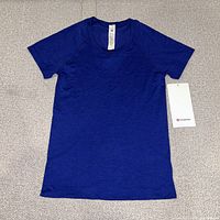 Front view of blue Swiftly Tech shirt with tag attached