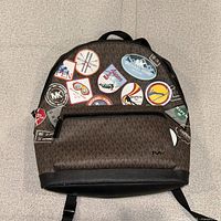 Front view showing MK monogram pattern and patch graphics