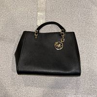 Front view of satchel showing overall shape and leather texture