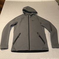 Front view of grey Nike full-zip Therma-FIT hoodie