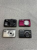 Front view of four Nikon Coolpix cameras