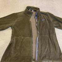 Front view of Patagonia olive fleece jacket fully zipped
