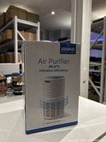 Front of sealed RENPHO air purifier box showing product image and 99.97% filtration efficiency text