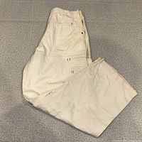 Full side view of beige snowboard pants folded