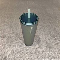 Full view of Starbucks green cold cup with lid and straw