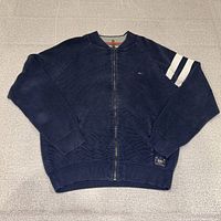 Front view displaying overall design, sleeve stripes and zipper