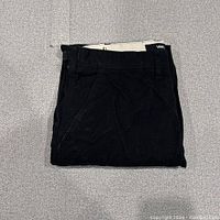 Folded black Vans cargo pants