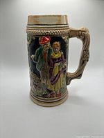 Front view showing couple in traditional attire and ornate handle