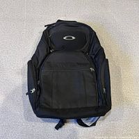 Front view of black Oakley Icon backpack showing logo and compartments
