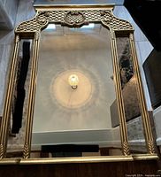 Front view of gold ornate mirror showing full frame and glass