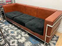 Full view of sofa showing frame, upholstery and cushion covers