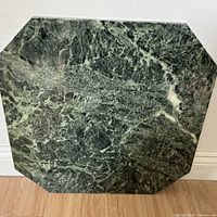 Full view of the green mottled marble slab leaning against wall
