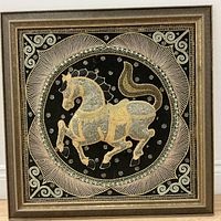 Full view of framed embroidered horse textile