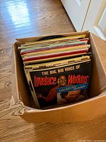 Box of vinyl LPs, front record Lovelace Watkins visible
