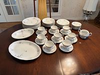 Entire 48-piece Rhone floral dinnerware arranged on table
