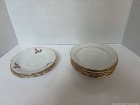 Two separate stacks of saucers showing quantity and two design types