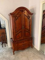 Full view of cherry wood armoire showing two-piece construction and overall condition