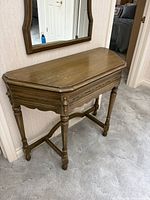 Front view of console table showing overall design and mirror above not included