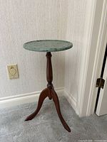 Full view of table showing granite top and wooden tripod base