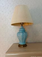 Full view of lamp with shade on tabletop