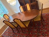 Full dining set: oval table, six chairs on rug