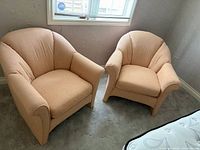 Both Sklar-Peppler peach armchairs side by side