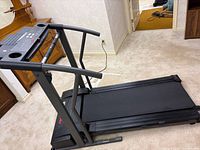 Full view of ProForm 595 LE treadmill folded flat on floor