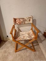 Full view of director's chair showing wooden frame and floral fabric