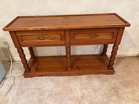 Front view showing drawers, legs, lower shelf