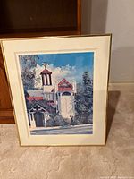Whole framed print leaning against cabinet