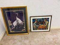Both framed prints leaning against wall