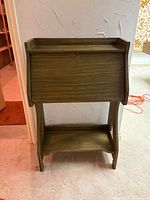 Full front view of closed drop-front desk with lower shelf