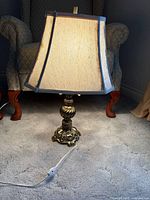 Full view of lamp with shade lit and cord visible