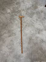 Full view of the wooden cane laid flat