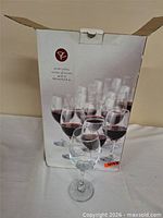 Retail box front showing image of wine glasses and branding