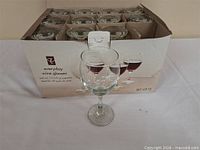 Closed carton of 12 wine glasses with one glass displayed