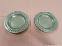 Two pewter plates side by side showing overall form and size