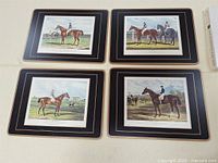Four Pimpernel Traditional place mats laid out showing equestrian artwork and black borders