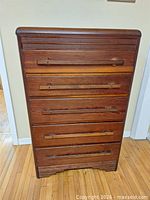 Front view of tall 5-drawer wooden dresser