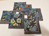 Six square cotton napkins laid out, showing pattern