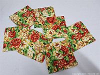 All seven floral napkins arranged displaying pattern