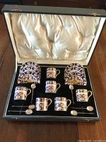 Presentation case with six cups, saucers and six sterling spoons