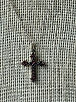 Front view of cross pendant on display chain