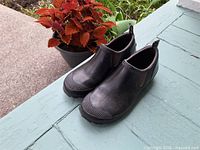 Full view of both shoes on porch showing overall condition
